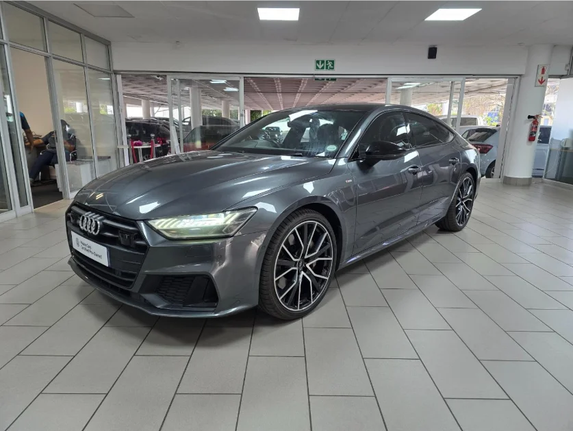 Original photo of a grey Audi inside a dealership